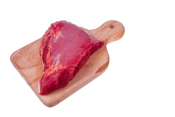 Raw beaf steaks on a wooden board.