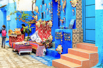 Colorful Moroccan fabrics and handmade souvenirs on the street in the blue city Chefchaouen, Morocco, Africa..