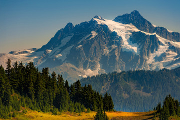 Fototapeta na wymiar Mt. Shucksan As Seen From The Excelsior Ridge Trail. On this trail Mount Shuksan seems close enough to touch just across the valley, and wildflowers are everywhere in summer.