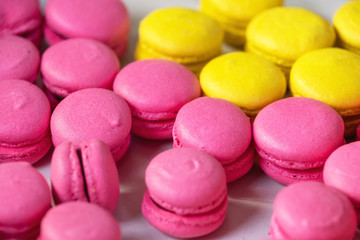 Fototapeta na wymiar Traditional French dessert colorful pink and yellow macaroons .