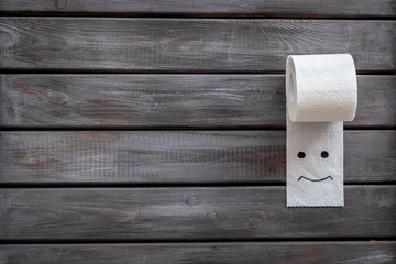 Toilet paper roll on wooden background top view mockup