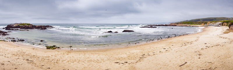 Sandy beach on a cloudy day on the Pacific Ocean coastline, Pescadero State Beach, California