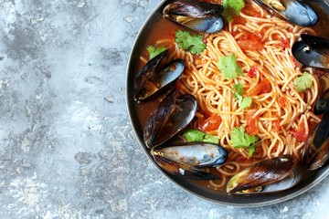 Pasta Spaghetti with mussels, tomato sauce. sea food meal. Mussels Marinara. Typical dish of Italian pasta.  top view.