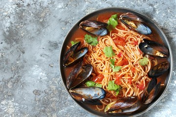 Pasta Spaghetti with mussels, tomato sauce. sea food meal. Mussels Marinara. Typical dish of Italian pasta.  top view.