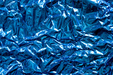 Texture of crumpled blue foil plastic. Concept of global Warming.