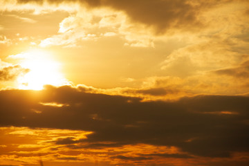 Evening weather, Golden sky and cloud with Light sunshine, Dark shadow meadow in the field.