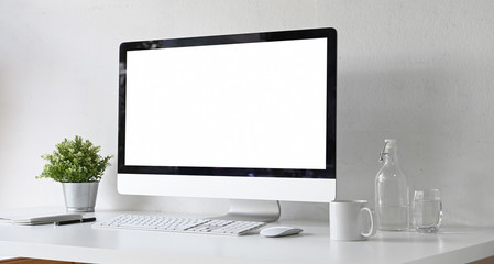 Mock up blank screen computer in minimal work space