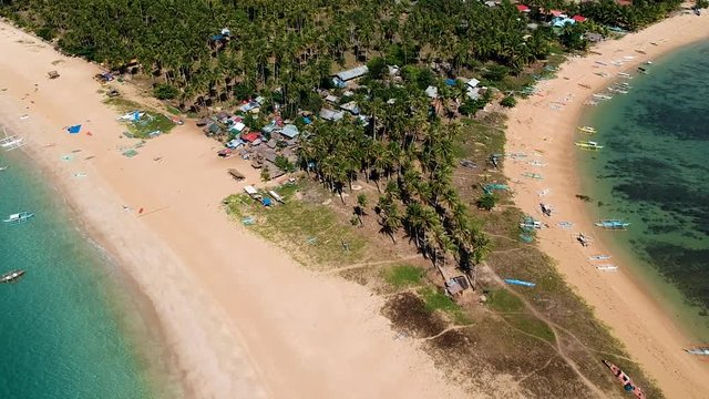 Aerial rotating reveal of double beach and Nacpan beach, El Nido , Palawan, Philippines