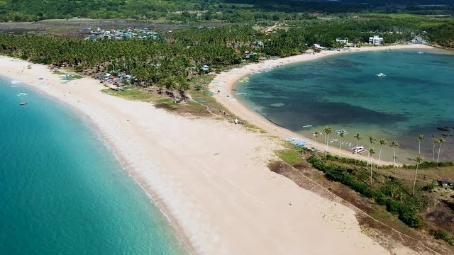 Cinematic aerial reveal of Double beach at Nacpan beach, El Nido , Palawan, Philippines