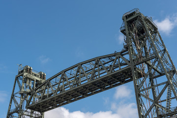 Fototapeta na wymiar Top of Monumental Koningshaven Railway Bridge - de Hef - against blue sky in Rotterdam, Netherlands