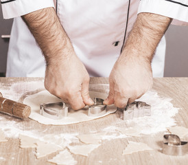 male cook preparing Christmas cookies