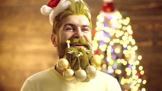 Christmas decorations. Attractive bearded hipster. Beard with Christmas decoration. Merry Christmas and happy New year. Man New Year eve. Delivery gifts.
