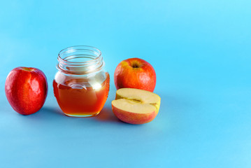 Honey and apple over blue background. Healthy food. Copy space for text.