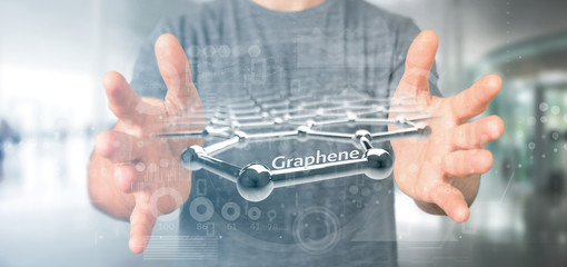 Obraz na płótnie Canvas Businessman holding a graphene structure - 3d rendering
