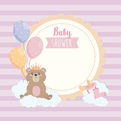 label of teddy bear wearing crown with balloons and ribbon