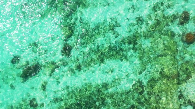 philippines aerial view of clean crystal water with rocks beneath it near tropical islands