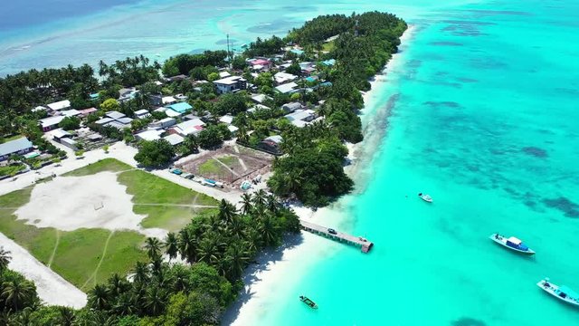 thailand footage of tropical island with buildings and ships and crystal clean ocean water around