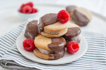 Sweet delicious ice cream cookie sandwiches on table