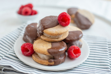 Sweet delicious ice cream cookie sandwiches on table