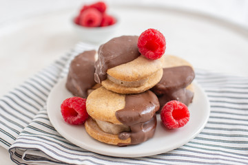 Sweet delicious ice cream cookie sandwiches on table