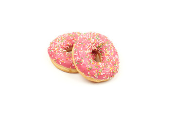 Pink donut with colorful sprinkles isolated on white background.