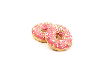 Pink donut with colorful sprinkles isolated on white background.