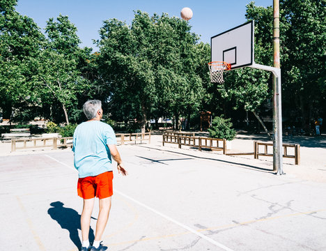 Old Man Playing In A Basketball Court