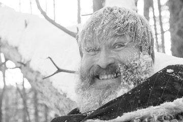 Bearded man in the forest after swimming in the snow