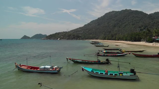 Aerial drone footage of Sairee (Sai Ri) Beach, Koh Tao, Thailand.
Ocean, corals, blue sea and long tail speed boats can be seen in the foreground with Sairee beach behind.