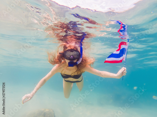 Happy woman in snorkeling mask dive underwater with tropical fishes with thailand flag in coral reef sea pool. Travel lifestyle, water sport outdoor adventure, swimming lessons on summer beach holiday