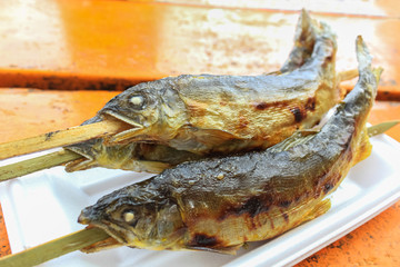 Grilled Ayu fish with salt at Kegon Waterfall, Japan.