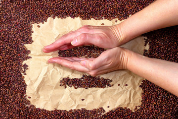 Girl's hands playing with dried grape seeds