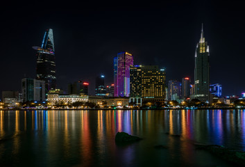 Obraz premium The best of night view in Ho Chi Minh City, Vietnam. Colorful of city light beside the Saigon river with skyline at sunset. Royalty high quality free stock image.