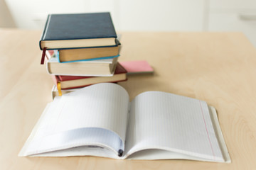 Stack of books on wooden table. Heap fo books on wooden background. Education concept.