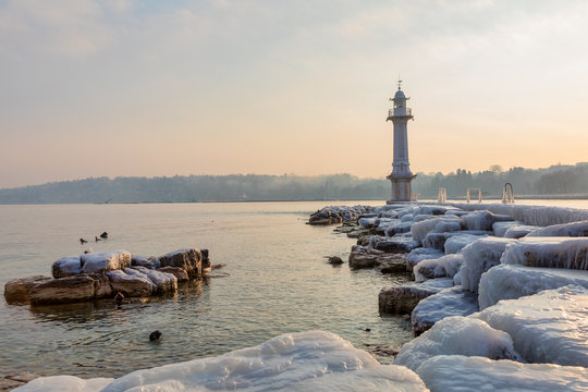 Lighthouse at Bains des Paquis covered in ice, Geneva, Switzerland