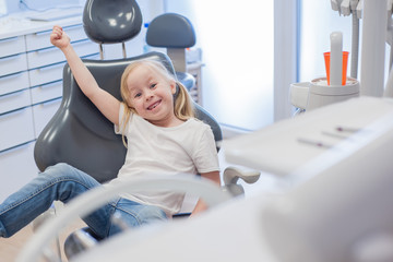 Fototapeta premium cheerful little girl in the dental chair. control at the dentist.