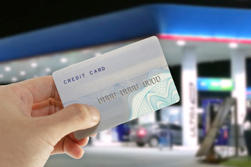 Credit card with mobile phone to make a payment for refueling car on gas station