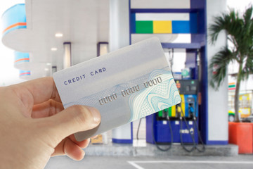 Credit card with mobile phone to make a payment for refueling car on gas station