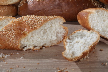 baguette cutting on the background of buns and bread