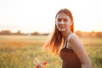 cheerful girl on the field. portrait. concept of freedom and independence