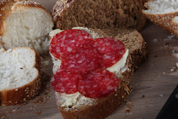 bread with sesame, butter and sausage close-up