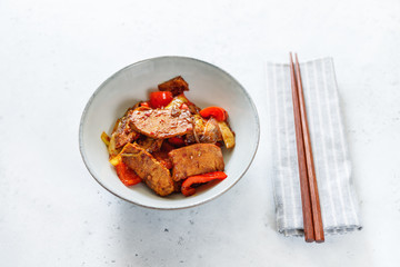 Szechuan traditional dish Hui Guo Rou, spicy roasted pork with leek and bell pepper. Portion size, top view.