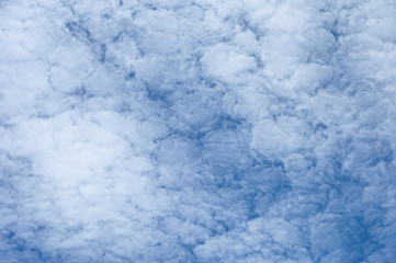 White clouds cluster on blue sky background