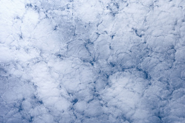 White clouds cluster on blue sky background