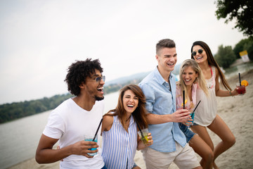 Group of friends enjoying beach vacation and having fun