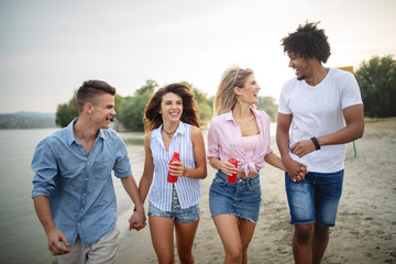 Group of friends having fun at the beach on a sunny day.