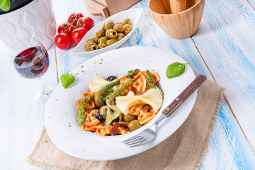 colorful farfalle with green asparagus olives and parma ham