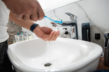 Close up of man hands washing tooth brush