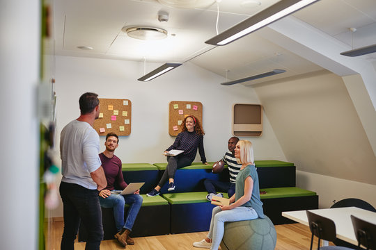 Group of smiling designers meeting together in an office