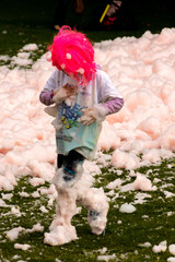 boy in red wig covered in bubbles